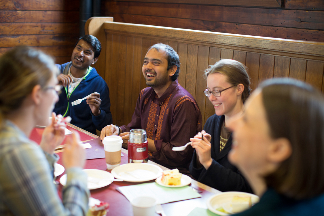 Students around a table eating and drinking