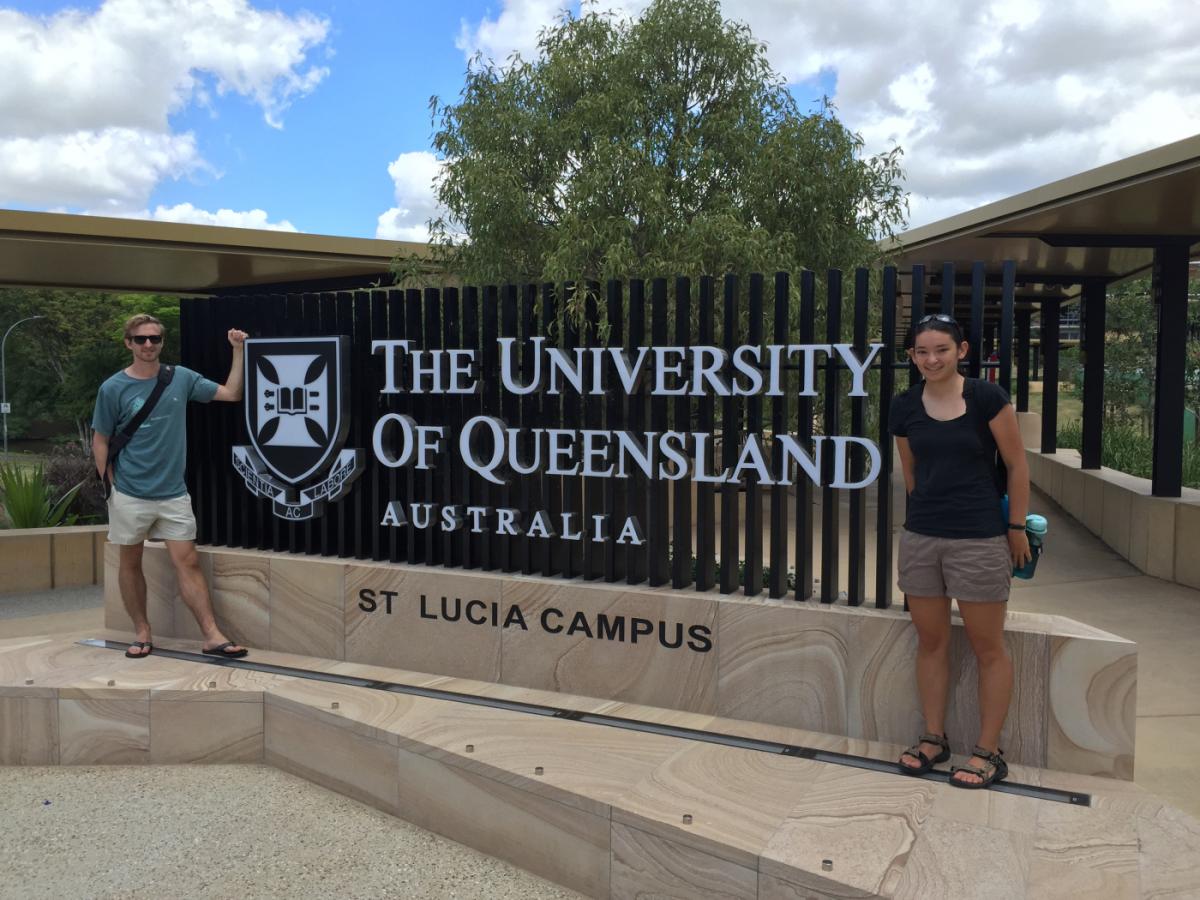 Kalia Bistolas standing in front of the University of Queensland welcome sign in Australia