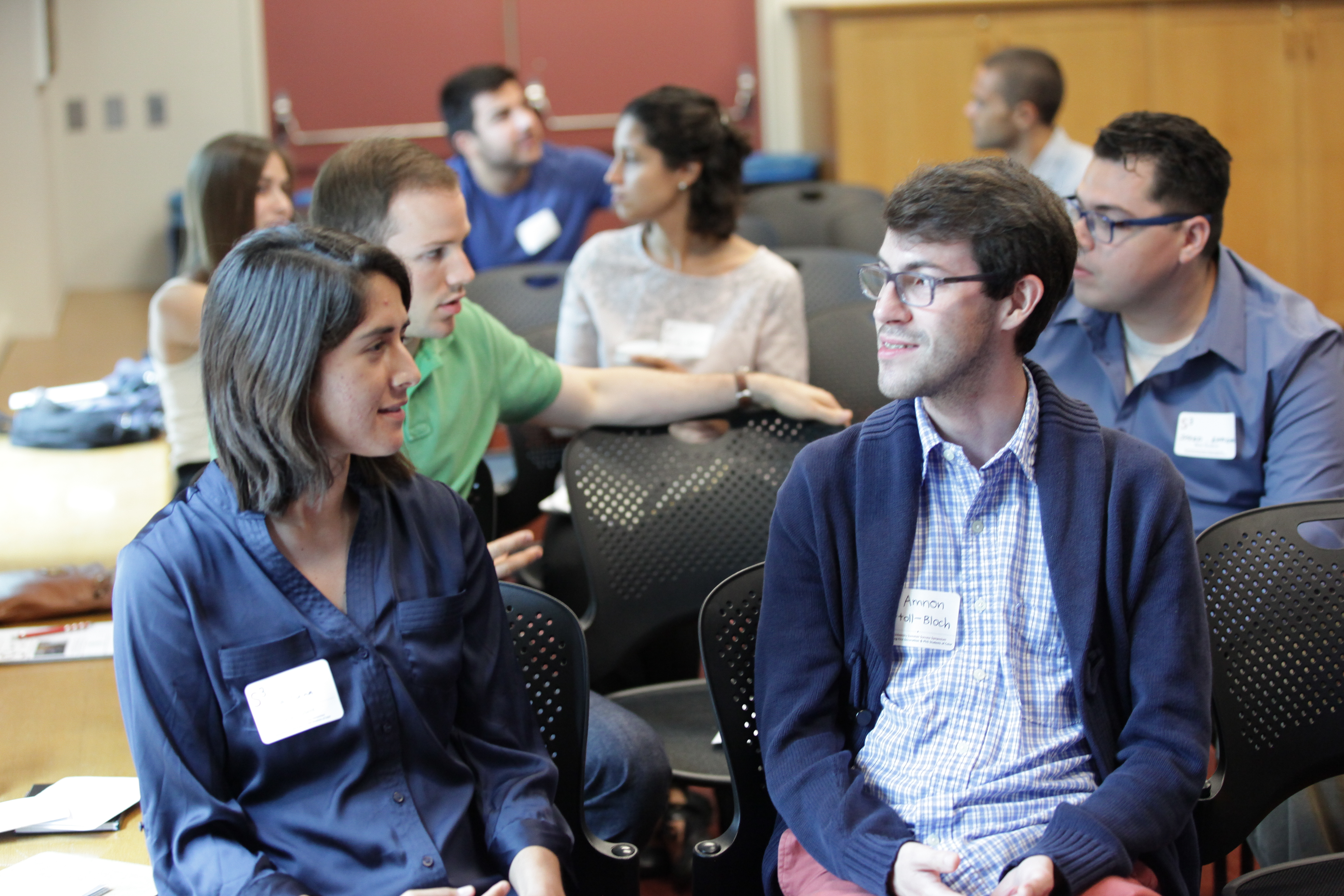 Amnon Ortoll-Bloch and a colleague engage in discussion at the Summer Success Symposium