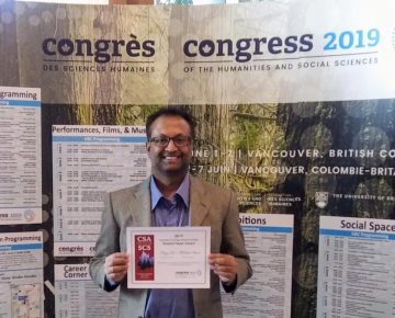 Abdullah Shahid with award