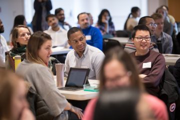 Symposium participants listen attentively to the speaker