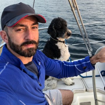 Jason Kahabka on his boat with dog, Archer