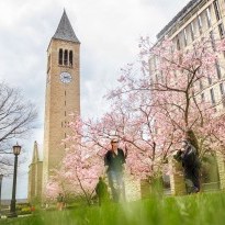 Students pass by McGraw Tower in spring