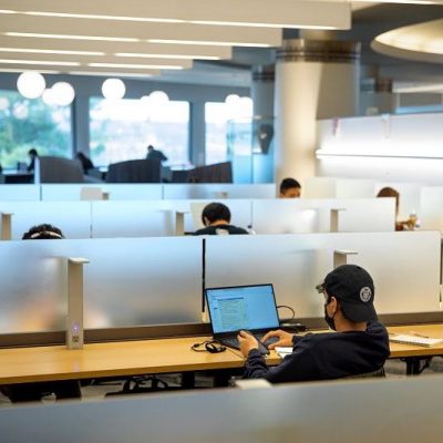 Student working on laptop in Uris Library