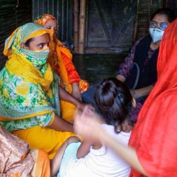 Sharifa Sultana conducts a focus group with women on their porch in Jessore in 2020 as part of her ethnographic work in Bangladesh.