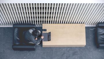 Overhead view of single student working on laptop at a table