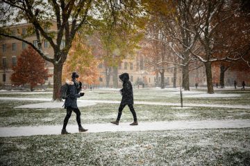 Students cross a snowy Ag Quad