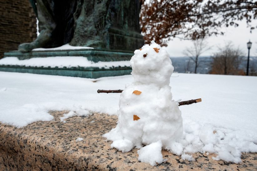 Snowman by the Ezra Cornell statue on the Arts Quad