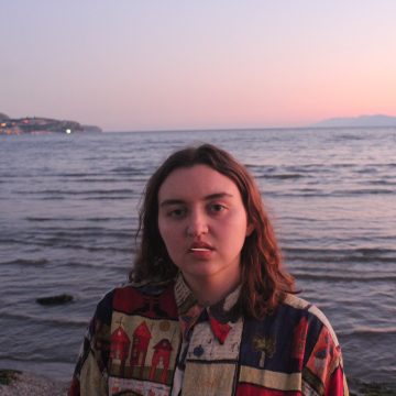 Mackenzie Berry stands in front of the ocean