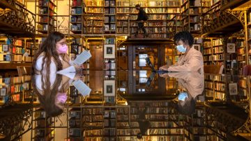 Students in masks work in a Cornell Library