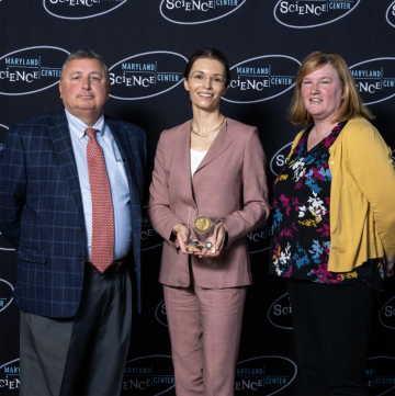 Mark J. Potter; Elizabeth Strychalski, M.S. '07, Ph.D. '09, holding an award; and Mollie Mulherin Thompson