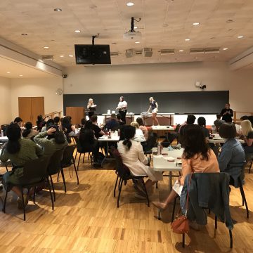 A new doctoral candidate is recognized onstage by Associate Dean Jan Allen in front of a room of new doctoral candidates during the inaugural Admission to Candidacy Recognition Ceremony.