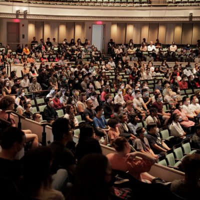 Incoming graduate and professional students sit in the Bailey Hall Auditorium