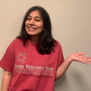 Ambika Pachaury wears a shirt reading, 'Daniel Research Team. Come get bio-inspired with us!'