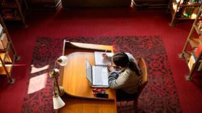 Students work in their reserved study spaces in the AD White Library.