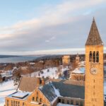 Aerial view of McGraw Tower with Cayuga Lake in the background after snowfall