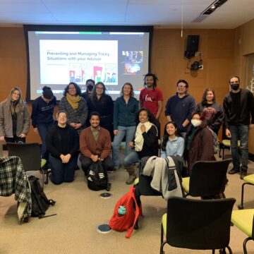 MAC Mentoring Program participants in front of a PowerPoint slide with a title on working with mentors