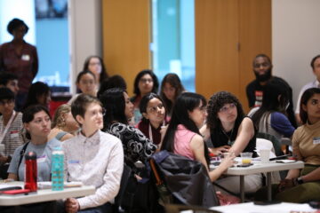 Graduate students listen to a speaker