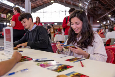 Students write postcards as part of the Gratitude Project at the 2023 Grad Connect resource fair