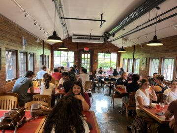 Students sit in the now air conditioned greenhouse section of the Big Red Barn