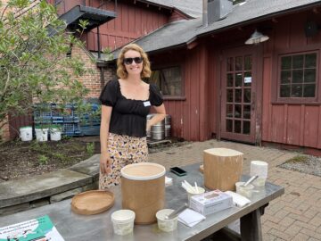 Melia Matthews scoops ice cream at an event at the Big Red Barn