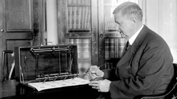 J.L. Summers with a check signing machine