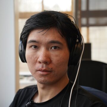 Ruidong Zhang wearing headphones he worked on as part of a research project