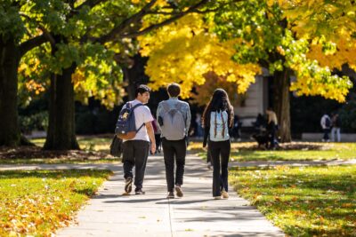 Students cross the Ag Quad in the afternoon sun in late summer.