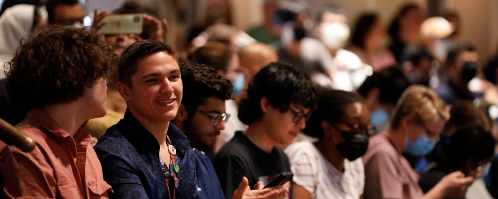 Two students talk prior to the start of the Dean's Welcome