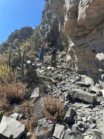 Holly Sexton and two colleagues stand on a rocky incline