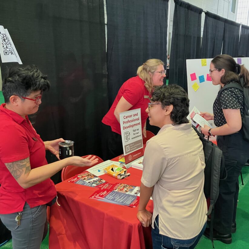 Members of the Graduate School Career and Professional Development team speak with students at the Grad Connect resource fair