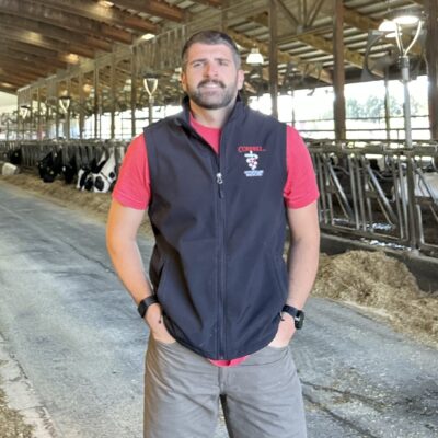 Adam Beard with cows behind him