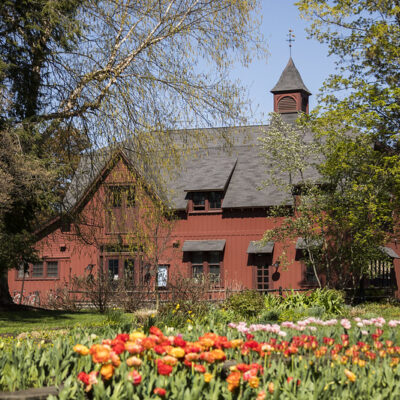 Flowers bloom in front of the Big Red Barn