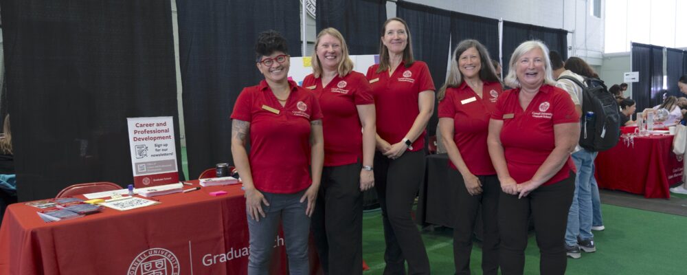 The Graduate School Office of Career and Professional Development team in red shirts at a resource fair