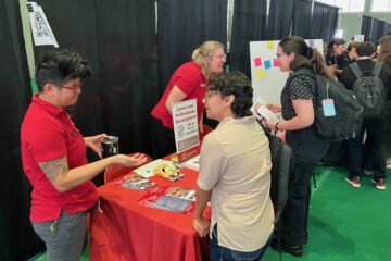 Members of the Graduate School Career and Professional Development team speak with students at the Grad Connect resource fair