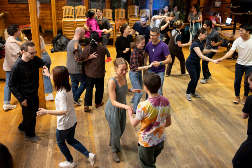 Students participate in a swing dance event at the Big Red Barn