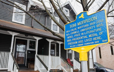 A historical sign stands in front of an Ithaca house, marking where Toni Morrison lived.