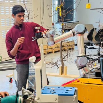 Divyanth Loganathan Girija handles equipment in a lab space