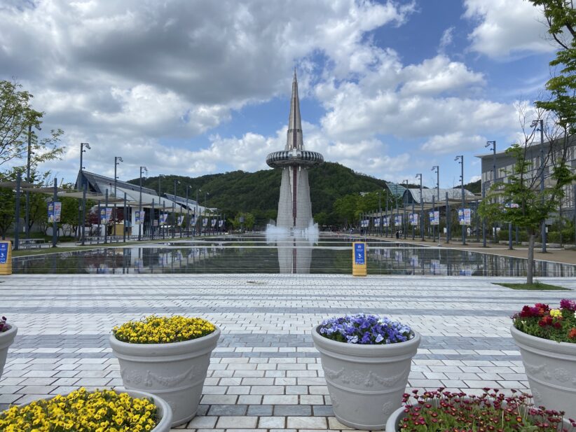 A tower stands at the back of a pool of water