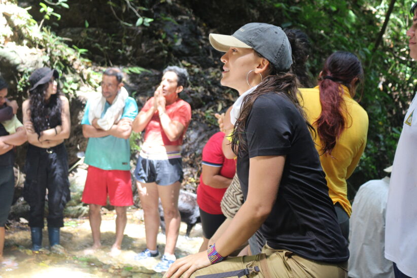 Elizabeth Gallego sits in a circle with local residents