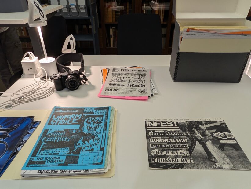 Flyers and a camera sit atop a work station